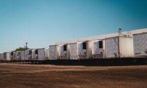 Refrigerated trucks parked in an industrial lot under a clear blue sky on a sunny day. - Photo by Tom Jackson on Pexels
