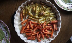 Top view of delicious pieces of roasted potatoes and carrots on plate with seasonings - Photo by Mateusz Dach on Pexels